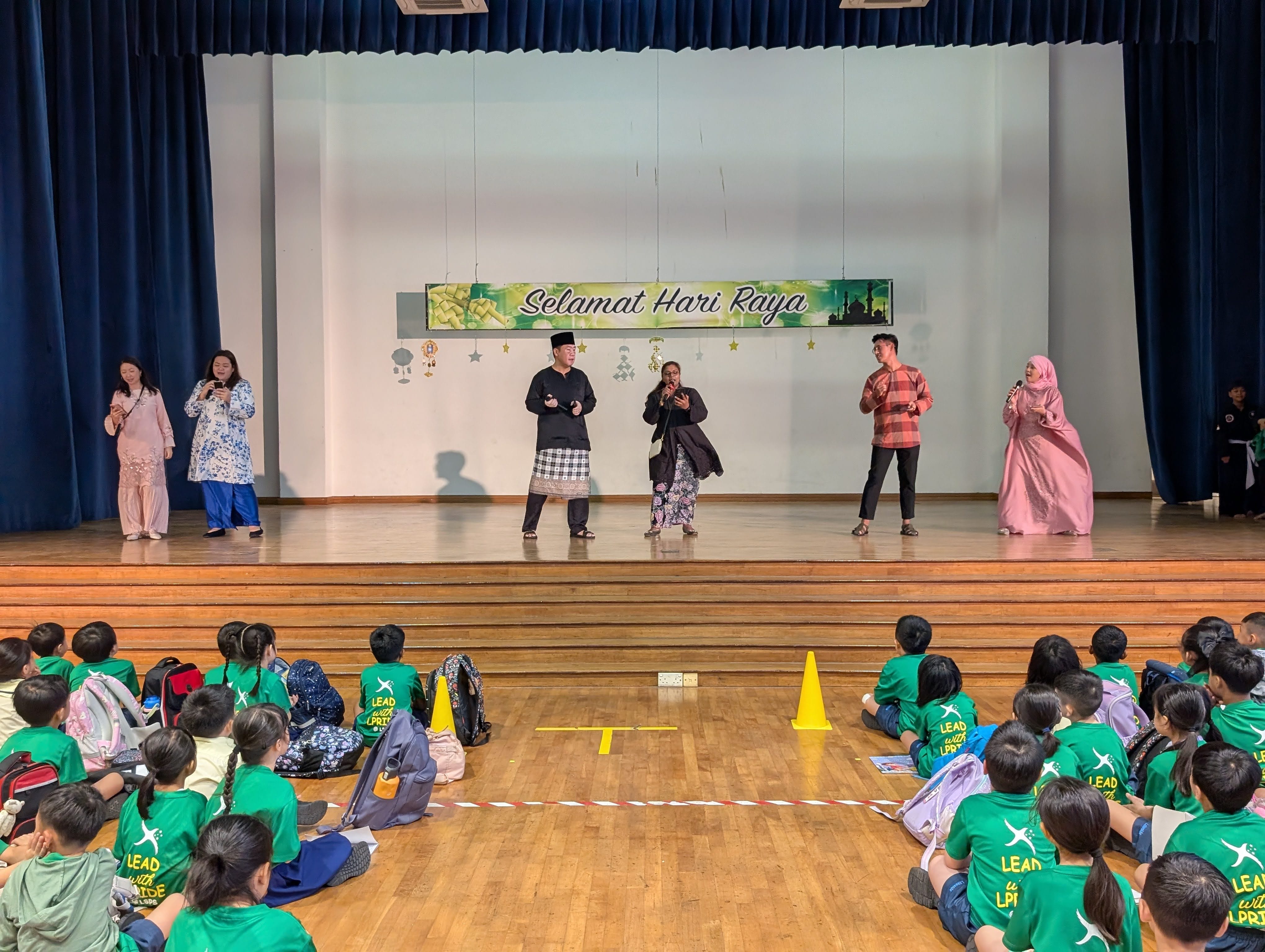 Teachers on stage bringing joy and festive spirit with their Hari Raya singing